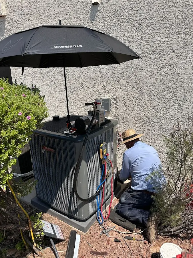 HVAC technician performing outdoor AC maintenance in Ham Lake